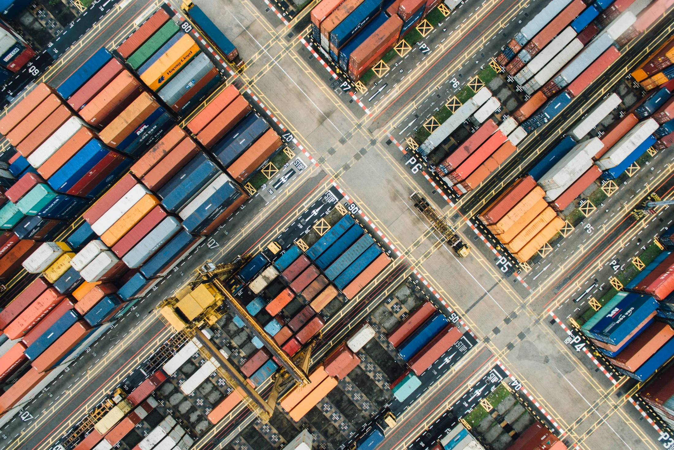 An overhead photograph of a working freight terminal with container stacks and access routes
